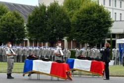 FILE - French Defense Minister Florence Parly pays tribute to the two French soldiers with the Barkhane force in Mali killed when their armored vehicle hit an improvised explosive device, during a tribute ceremony in Tarbes, Sept. 9, 2020.