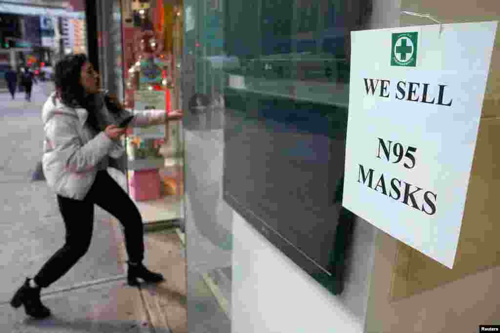 A woman walks into a pharmacy to purchase N95 face masks in advance of the potential coronavirus outbreak in the Manhattan borough of New York City.