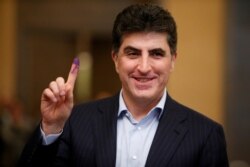 FILE PHOTO: Nechirvan Barzani shows his ink-stained finger after casting his vote at a polling station during the parliamentary election.