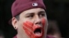 FILE - William Red Bear wears a red hand print image on his face as he marches in support of missing and murdered indigenous women during a rally to mark Indigenous Peoples' Day in downtown Seattle, Washington, Oct. 14, 2019. 