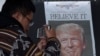 Zheng Gao of Shanghi, China, photographs the front pages of newspapers on display outside the Newseum in Washington, Nov., 9, 2016, the day after Donald Trump won the presidency.