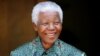 FILE - Former South African president Nelson Mandela smiles for photographers at his home in Johannesburg September 22, 2005.