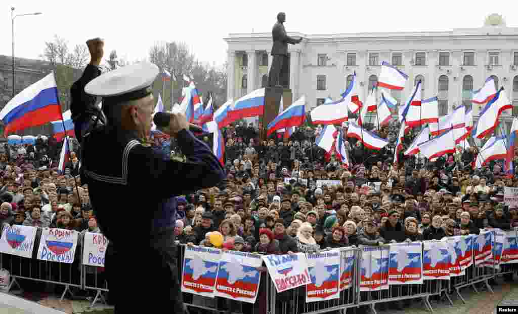 A member of the Russian Song and Dance Ensemble of the Black Sea Fleet performs during a pro-Russian rally in Simferopol, Crimea, March 9, 2014.