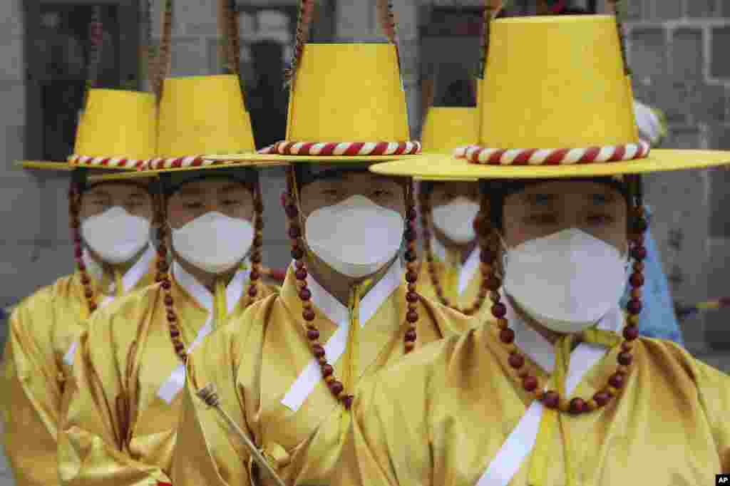 Imperial guards wear protective face masks during a reenactment of the Royal Guards Changing Ceremony in front of Deoksu Palace in Seoul, South Korea, Jan. 30, 2020.