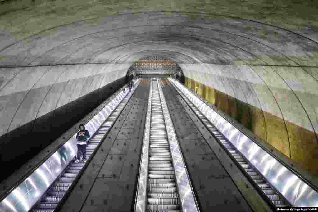 People descend down the Bethesda Metro train station escalator at commuter rush hour in Bethesda, Maryland as Governor Larry Hogan ordered the shutdown of all bars and eateries in the state due to the coronavirus disease, March 16, 2020.