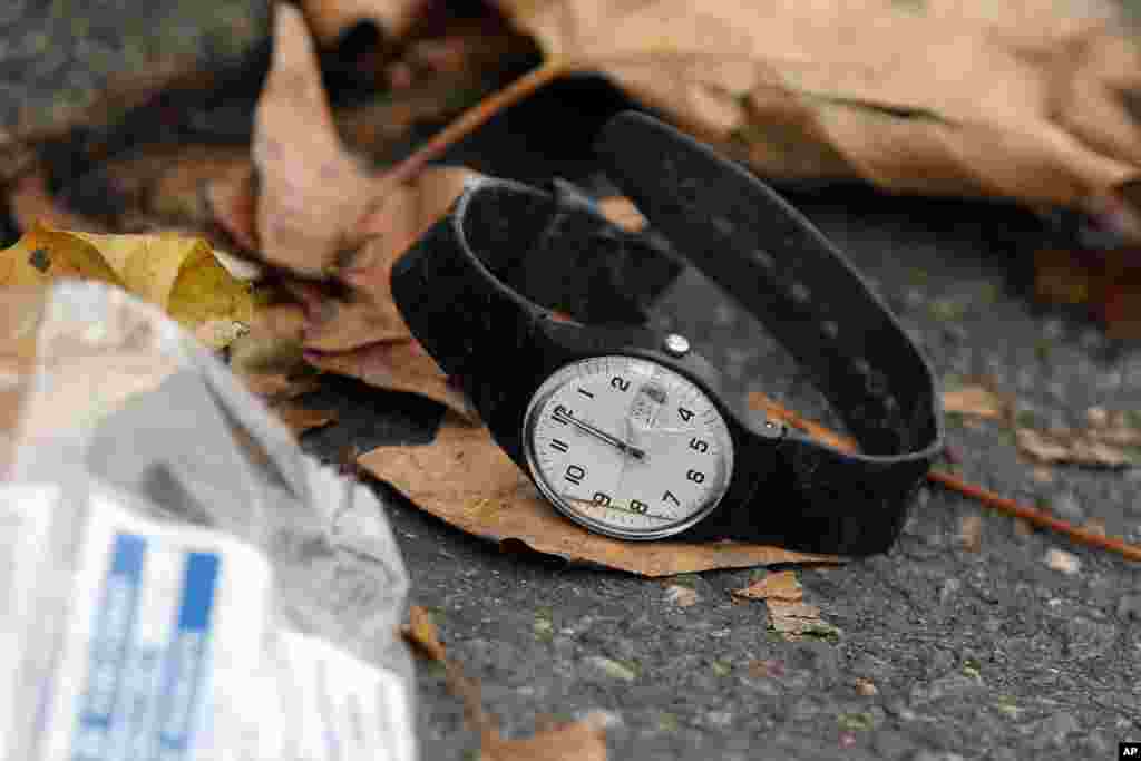 A watch lays on the ground outside the Bataclan concert hall, Nov. 14, 2015 in Paris.