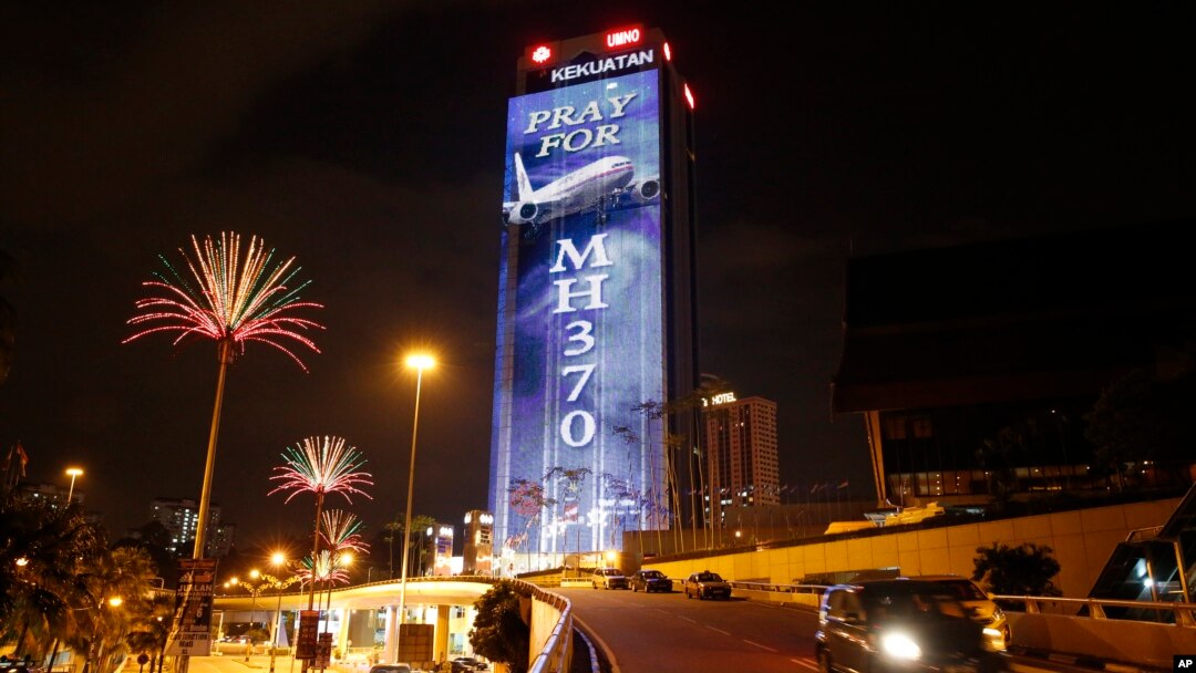 An office building is illuminated with lights displaying "Pray for MH370" in Kuala Lumpur, Malaysia, March 24, 2014. 