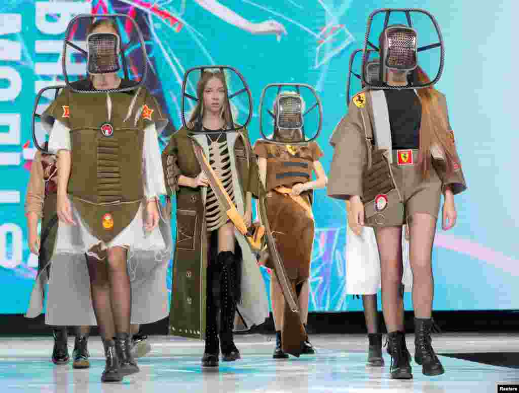 Models present creations "2033 (teens)" by Belarusian designer Anastasiya Kutepova during a show at the Fashion Mill, in Minsk.