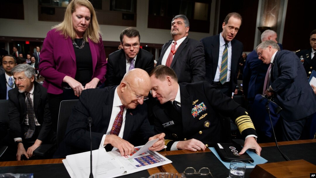 Director of National Intelligence James Clapper (L) talks with National Security Agency and Cyber Command chief Adm. Michael Rogers on Capitol Hill in Washington, Jan. 5, 2017, after a Senate Armed Services Committee hearing: "Foreign Cyber Threats to the United States." 