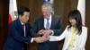 South Korea's Defense Minister Han Min-koo shows U.S. Secretary of Defense Jim Mattis and Japan's Defense Minister Tomomi Inada how to do a handshake during a trilateral meeting on the sidelines of the 16th IISS Shangri-La Dialogue in Singapore, June 3,