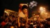 FILE - Followers of Shiite cleric Muqtada al-Sadr, seen pictured on the poster, celebrate in Tahrir Square, Baghdad, Iraq, May 14, 2018.