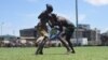 Two wrestlers grapple at the "Wrestling for Peace" tournament at Juba Stadium in South Sudan's capital, April 16, 2016. (J. Patinkin/VOA)