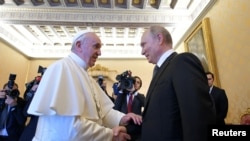 Russian President Vladimir Putin meets with Pope Francis at the Vatican, July 4, 2019. 