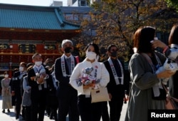 Owners of Sony's robotic dog 'Aibo' attend a ritual ceremony Sichi-Go-San, which is usually held for praying for children's health and wellbeing, in Tokyo