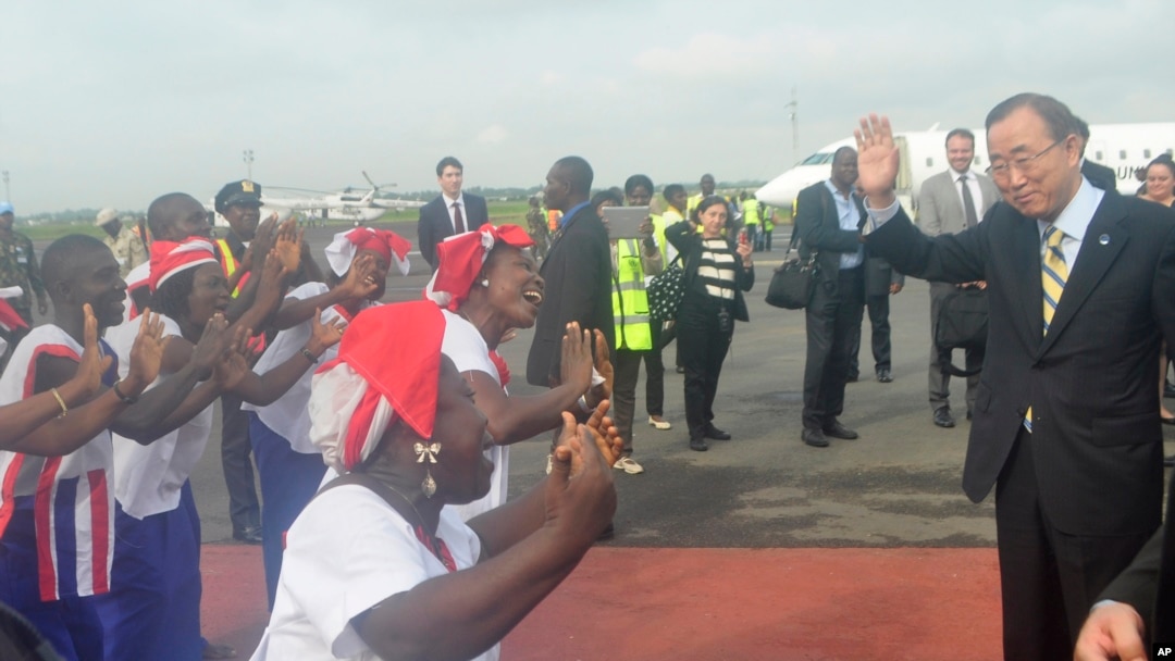UN Secretary General Ban Ki-moon, is greeted by dancers upon arrival at the Roberts international airport in Monrovia, Liberia, Friday, Dec. 19, 2014.