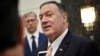 U.S. Secretary of State Mike Pompeo speaks to the media before departing from al-Bateen Air Base in Abu Dhabi, United Arab Emirates, Sept. 19, 2019, as U.S. special representative on Iran Brian Hook, left, listens. 