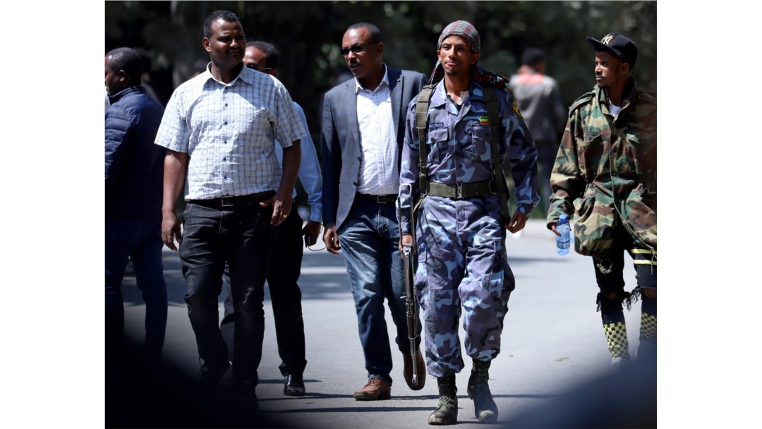 A federal police officer walks outside Jawar Mohammed's house, an Oromo activist and leader of the Oromo protest, in Addis Ababa, Ethiopia, Oct. 23, 2019.