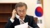 South Korean President Moon Jae-in speaks with Chinese President Xi Jinping by telephone at the Presidential Blue House in Seoul, South Korea, May 11, 2017.