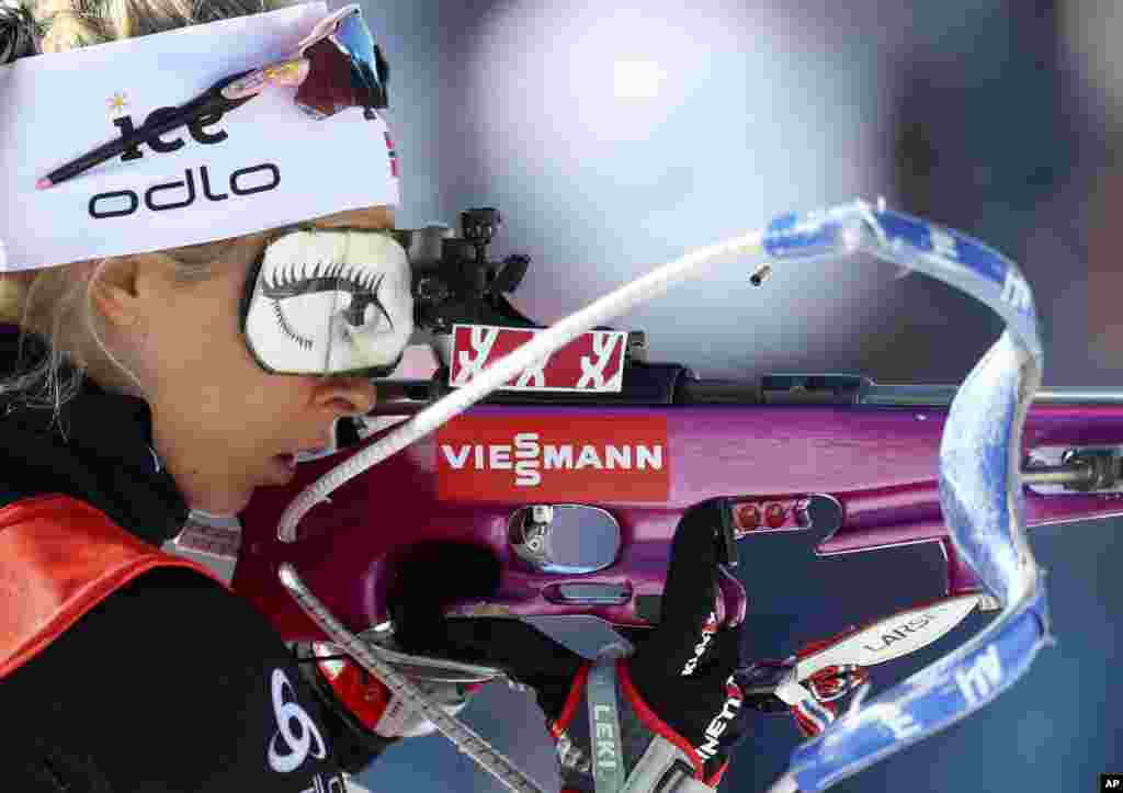 A spent cartridge pops out of the rifle of Ingrid Landmark Tandrevold of Norway during warmup before the women's 4x6 km relay competition at the Biathlon World Championships in Antholz, Italy, Feb. 22, 2020.