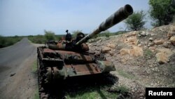 FILE - A tank damaged during the fighting between Ethiopia's National Defense Force and Tigray Special Forces stands on the outskirts of Humera, Ethiopia, July 1, 2021. 