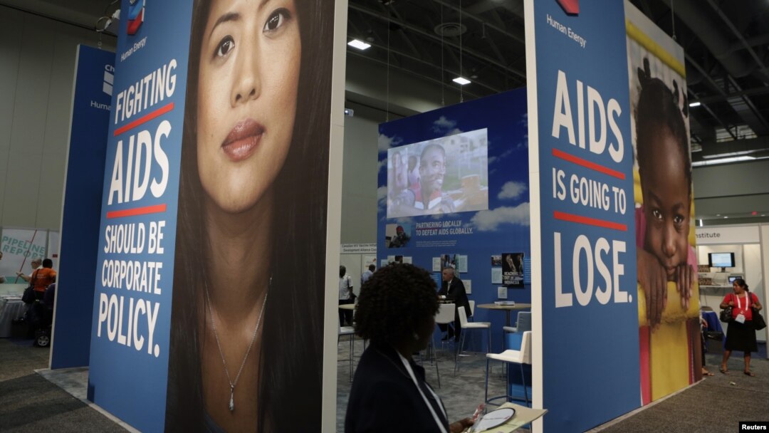 A visitor passes an exhibition at the International AIDS 2012 Conference in Washington