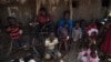 FILE - South Sudanese refugees who fled fighting between government and rebel forces wait in the shade of a dilapidated church near Aba, South Sudan, to be taken to a nearby refugee camp on Dec. 19, 2017.