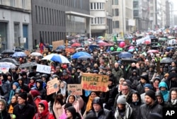 Protesters hold banners as they march during a "Rise for the Climate" demonstration in Brussels, Belgium, Jan. 27, 2019.