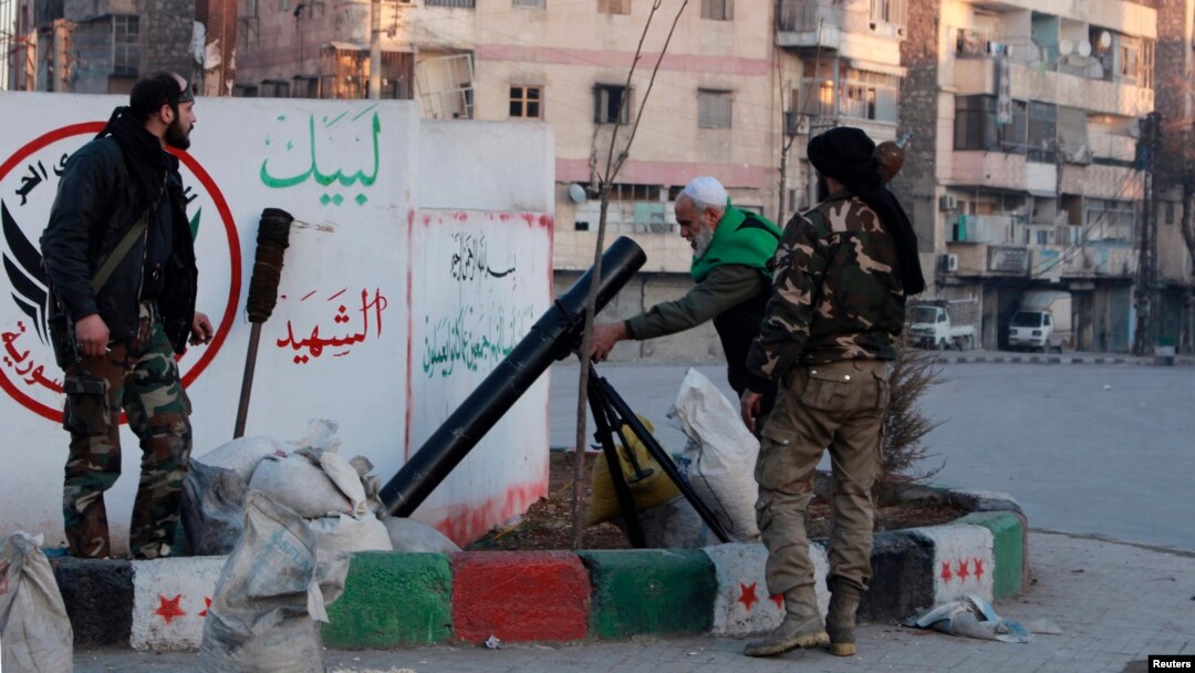 Free Syrian Army fighters prepare to launch a mortar towards fighters from the Islamic State in Iraq and the Levant from a street in the Kadi Askar neighborhood of Aleppo, Jan. 7, 2014. 