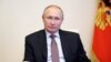 FILE - Vladimir Putin takes part in the signing ceremony of the general agreement between the All-Russian unions of trade unions, employers and the government of the Russian Federation, March 31, 2021. (Sputnik/Alexei Druzhinin/Kremlin via Reuters)