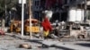 A Somali woman walks in front of Hotel Ambassador on Maka Al Mukaram Road in Somalia's capital Mogadishu, June 2, 2016. 