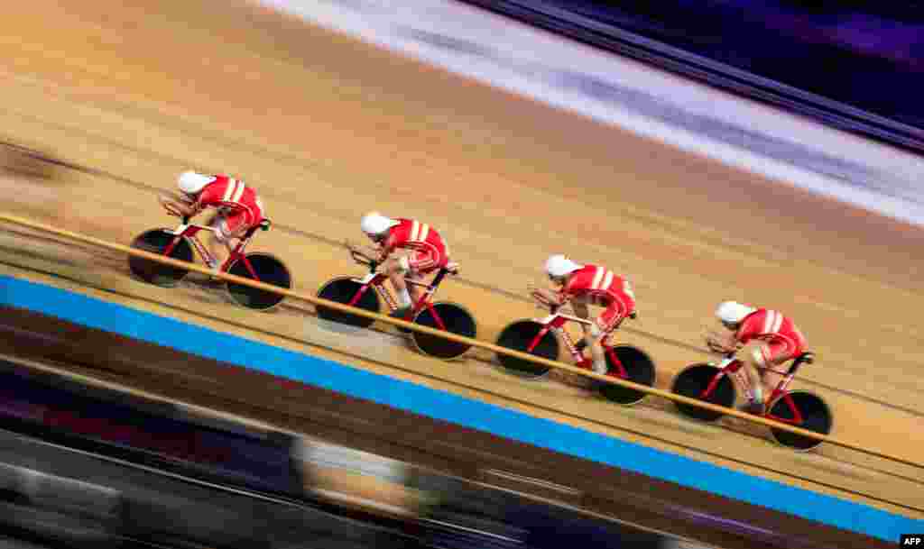 Denmark's team members Lasse Norman Hansen, Julius Johansen, Frederik Rodenberg Madsen and Rasmus Pedersen compete in the Men's Team Pursuit qualifying at the UCI track cycling World Championship in Berlin, Germany.