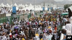FILE - Muslim pilgrims and rescuers gather around the victims of a stampede in Mina, Saudi Arabia, during the annual hajj pilgrimage, Sept. 24, 2015.