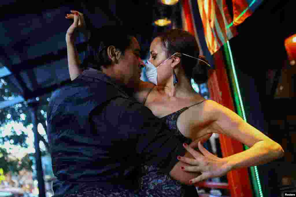Makrina Anastasiadou and her tango partner "El Morocho" dance for the public at an almost empty restaurant after tango shows, classes and milongas, traditional tango gatherings have been suspended for at least 15 days to prevent the spread of coronavirus in Buenos Aires, Argentina, March 16, 2020.