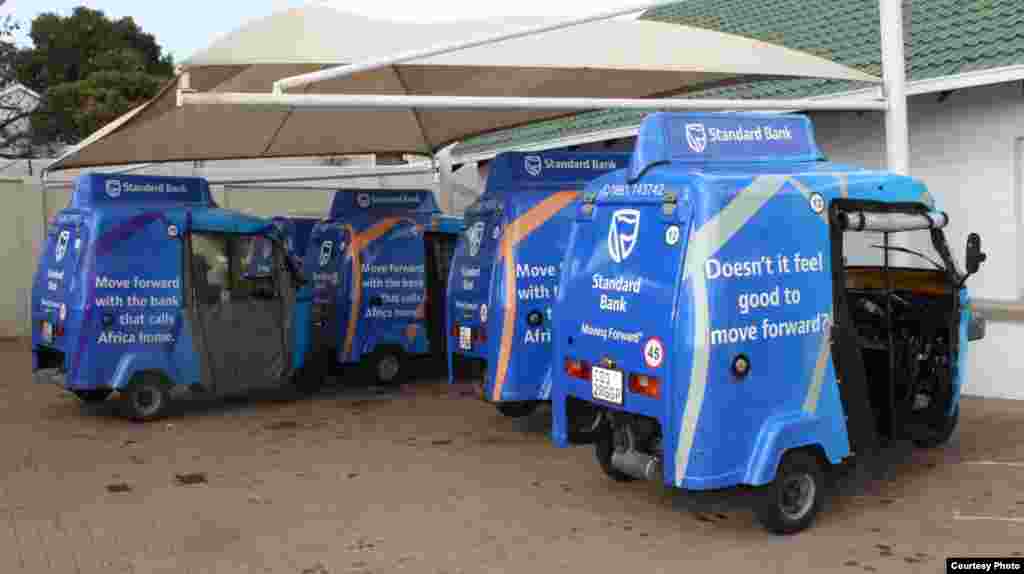 A small fleet of blue Shesha Tuks – advertising a local Standard Bank - await the call of the dispatcher at the company’s Johannesburg office. (Photo by Darren Taylor)