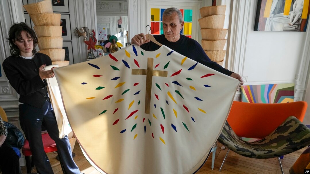 Designer Jean-Charles de Castelbajac displays a liturgical vestment for priests and to be worn at the December reopening of Paris' Notre-Dame Cathedral, Nov. 20, 2024.