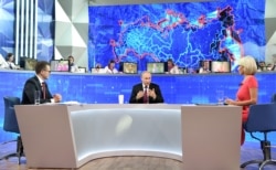 FILE - Russian President Vladimir Putin (C) speaks during an annual televised call-in show in Moscow, Russia, June 20, 2019.