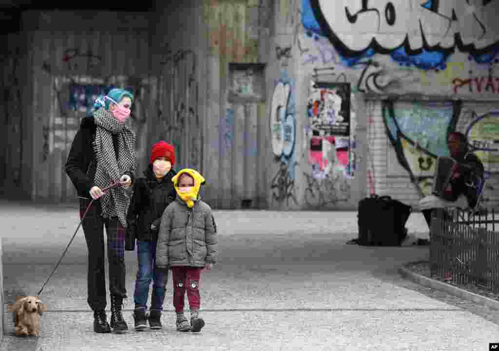 A woman with her children walk their dog in Prague, Czech Republic.
