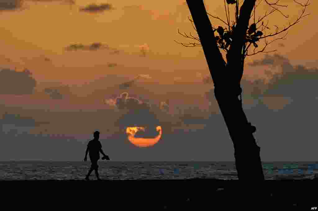 An Acehnese man watches the sunset at Meulaboh beach in Indonesia's Aceh province.