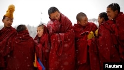 Tibetan monks attend a ceremony at the Langmu Lamasery during the "Sunbathing Buddha Festival", in Gannan Tibetan Autonomous Prefecture, Gansu Province, China, February 17, 2019. 