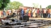 FILE - Suspected fighters and recovered weapons are shown in Bujumbura, Burundi, Dec. 12, 2015. Burundian President Pierre Nkurunziza's senior adviser says such images of unrest are propaganda intended to tarnish Burundi.