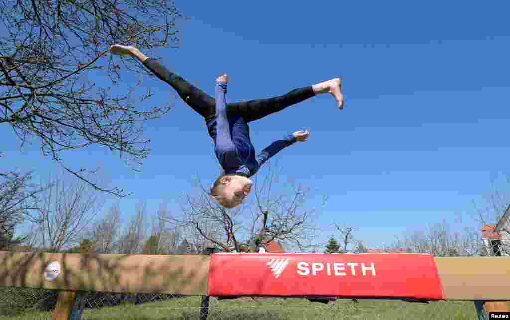 Clara Neumann, gymnast of the sports club Dresdner SC, trains in her parent's garden in Dresden, Germany, April 1, 2020.