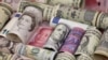 Euro, Hong Kong dollar, U.S. dollar, Japanese yen, British pound and Chinese 100-yuan banknotes, Jan. 21, 2016. 