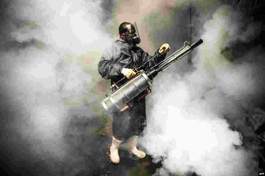 A member of a privately-funded NGO fumigates and disinfects the streets and the stalls at Parklands City Park Market in Kenya to help curb the spread of the coronavirus, April 15, 2020.