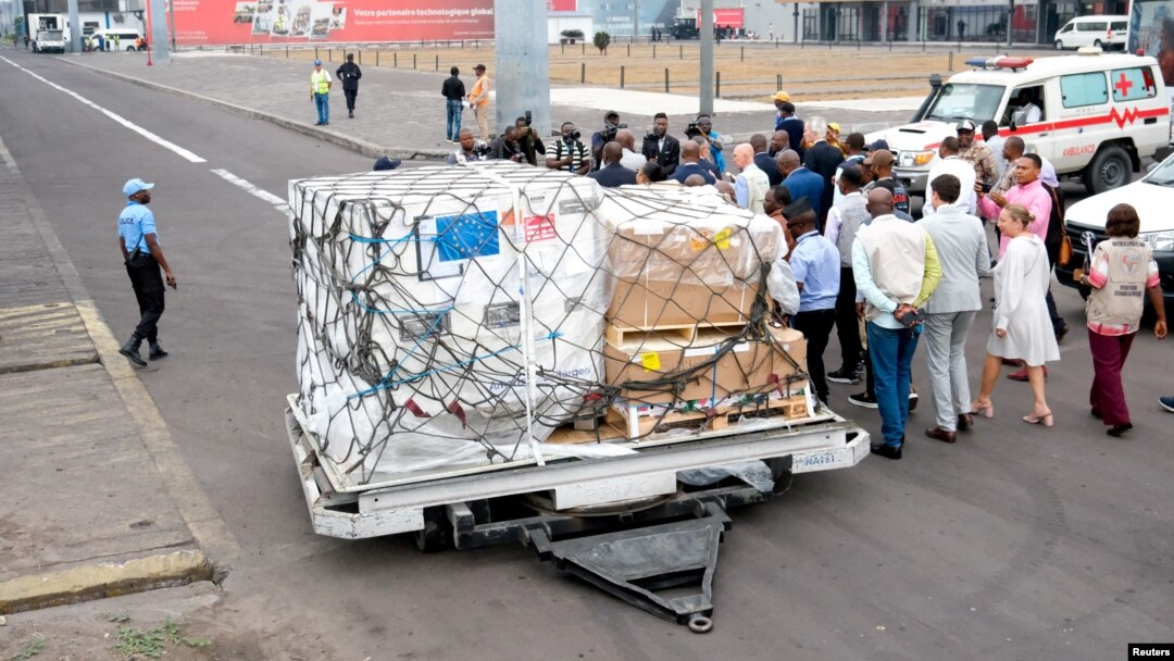 FILE - Officials stand near mpox vaccines as first batches from Europe arrive at N'Djili International Airport in Kinshasa, Democratic Republic of Congo, Sept. 5, 2024. DRC officials said the first doses from the United States arrived on Sept. 10, 2024.