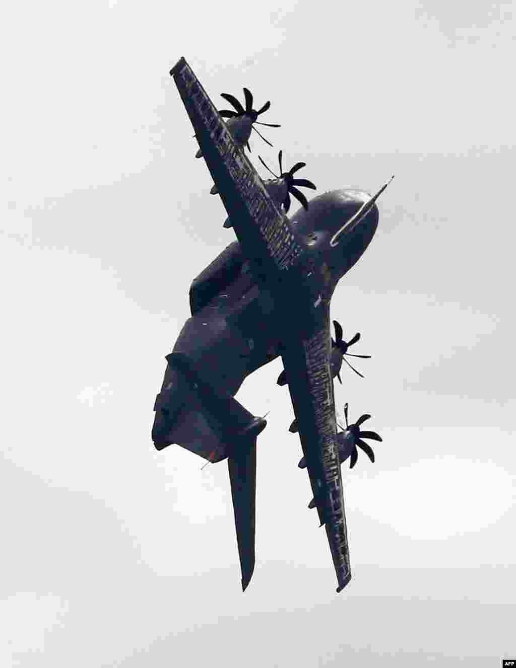 An Airbus A400M soars during the International Aerospace Exhibition (ILA) in Schoenefeld, Germany.