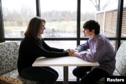 Danny Reagan, a former residential patient of the Lindner Center of Hope, sits in a common room with his mother Laurie Reagan at the center, in Mason, Ohio, Jan. 23, 2019.