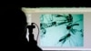 Evaristo Miqueli, a natural resources officer with Broward County Mosquito Control, looks through a microscope at Aedes aegypti mosquitoes in Pembroke Pines, Florida, June 28, 2016. The mosquitoes were collected from a residential home during a routine inspection, as part of the county's mosquito control procedure.