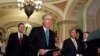 FILE - Senators Mitch McConnell (foreground) and Lindsey Graham approach a podium to speak to the media on Capitol Hill in Washington.