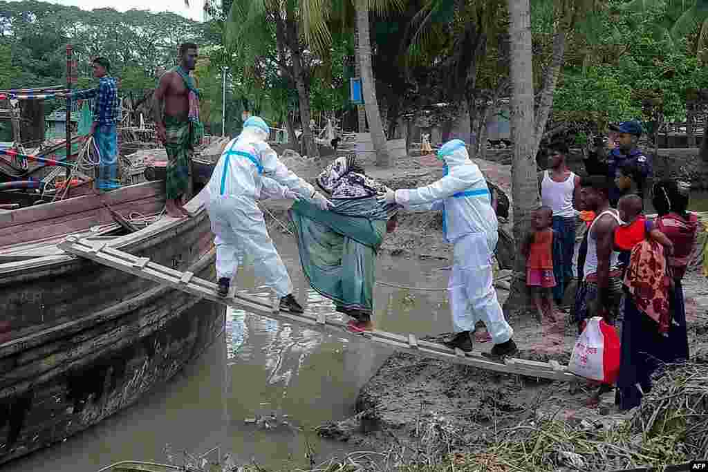 This handout photo released by the District Administration of Bhola shows residents being evacuted in Dhalchar village on the island of Bhola as Cyclone Amphan barrels toward Bangladesh's coast.