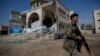 A Turkey-backed opposition fighter of the Free Syrian Army secures the streets of the northwestern city of Azaz, Syria, during a Turkish media tour into northern Syria, March 3, 2018.